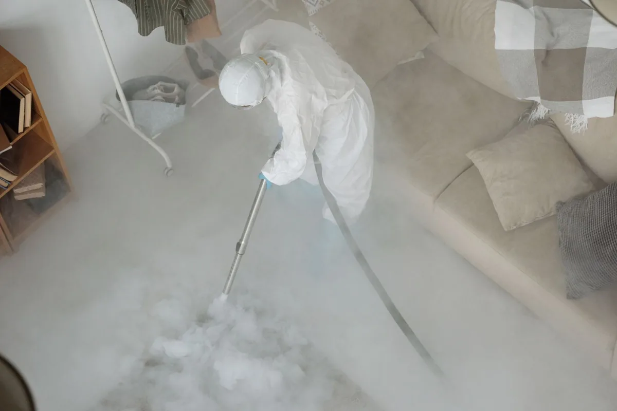 Biohazard cleanup technician in protective equipment, Sanger, TX